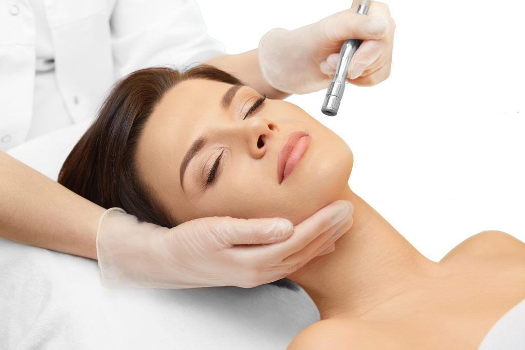 young woman rejuvenating skin with microdermabrasion